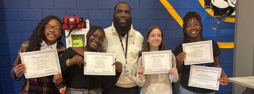 Students showing off their Academic Awards with Mr. Leach.
