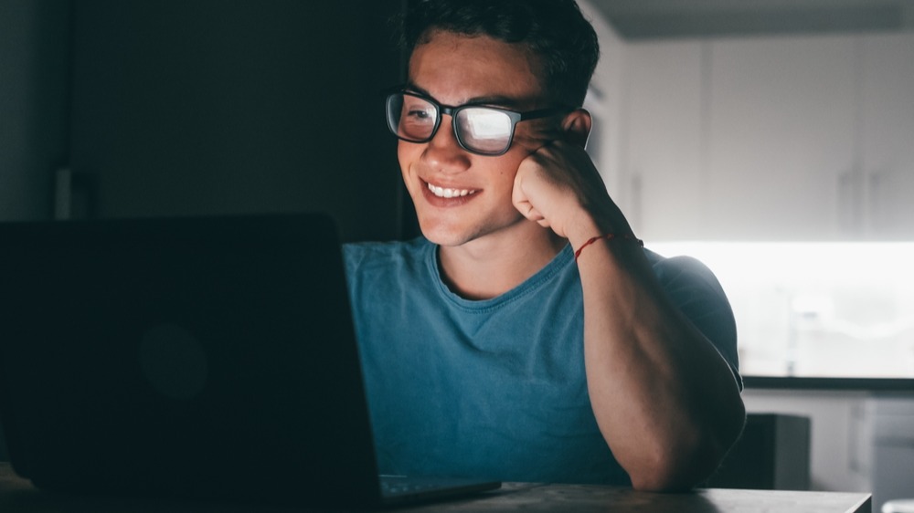 student in front of laptop in evening
