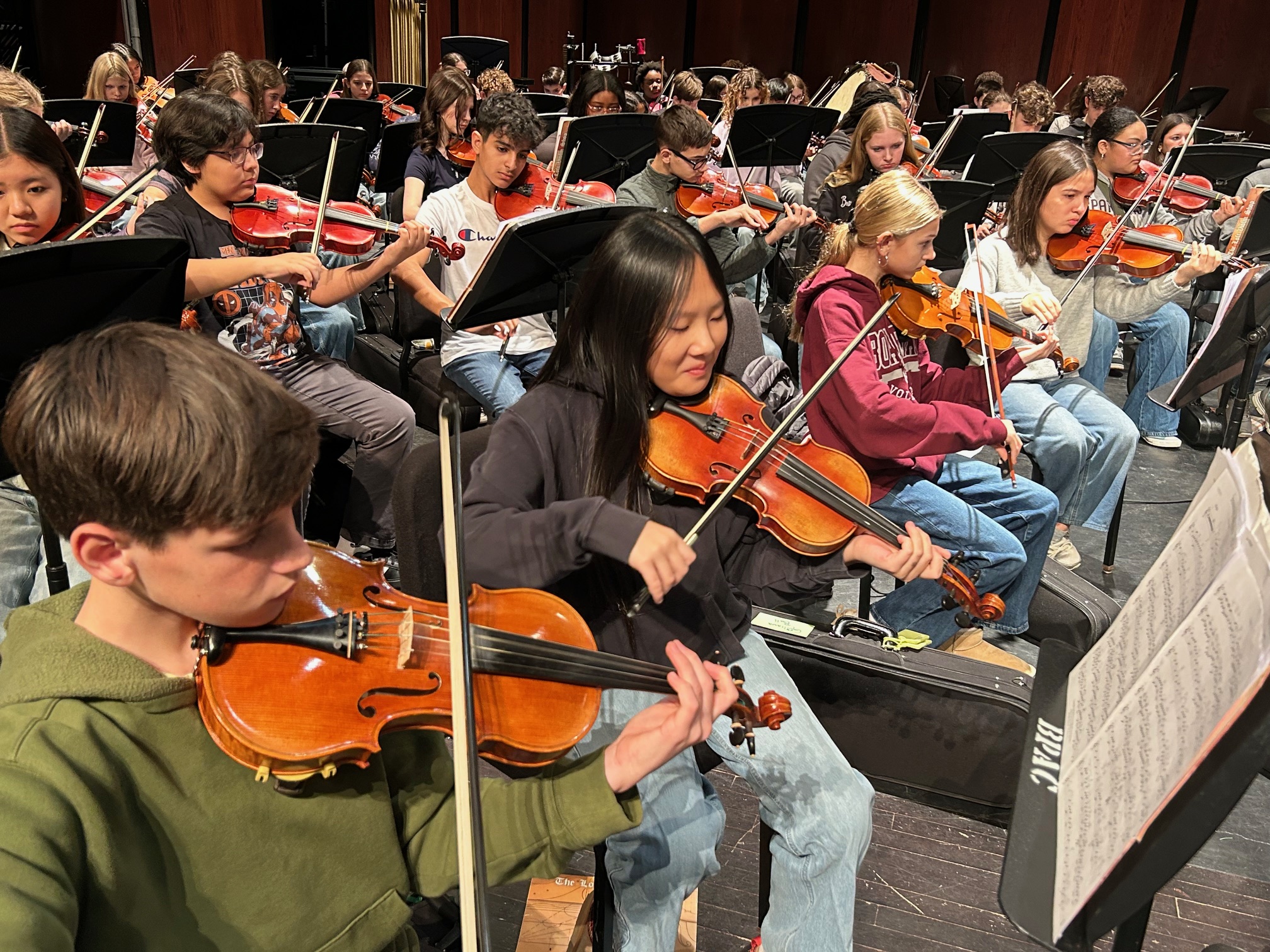 7th and 8th grade orchestra practicing on the performing arts stage