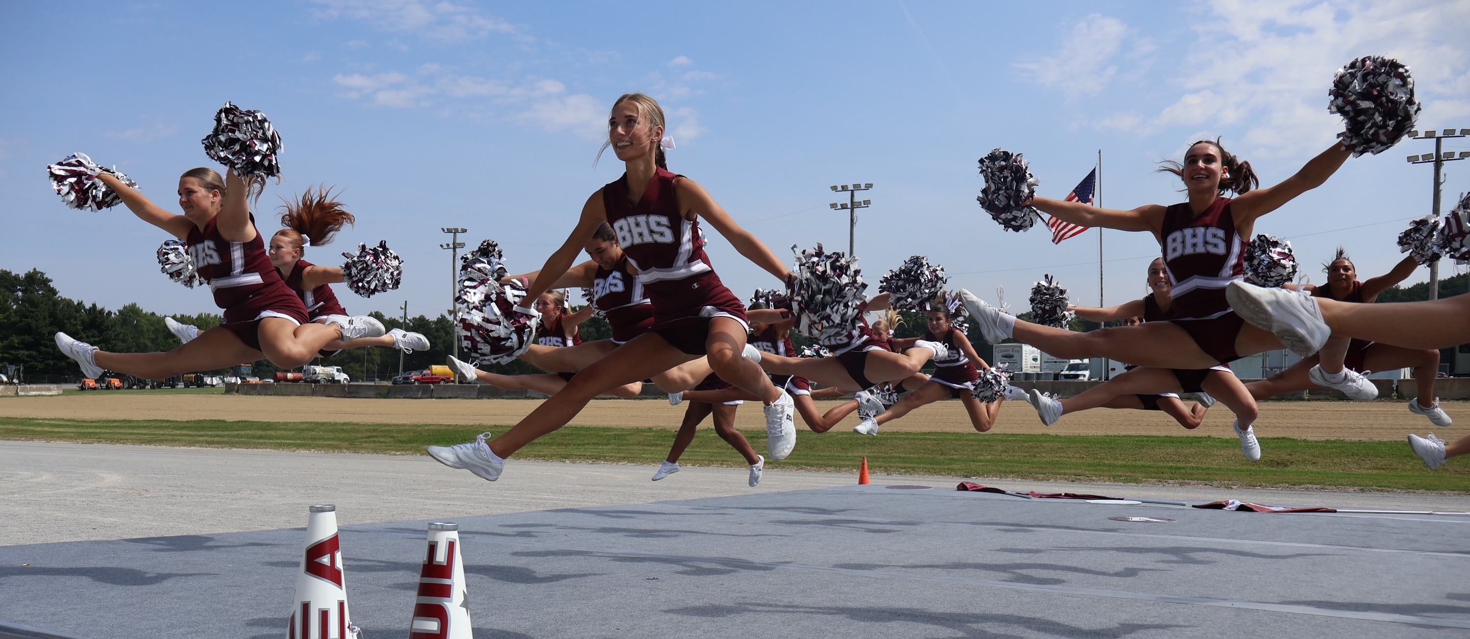 cheerleaders jumping as they perform at canfield fair grandstand