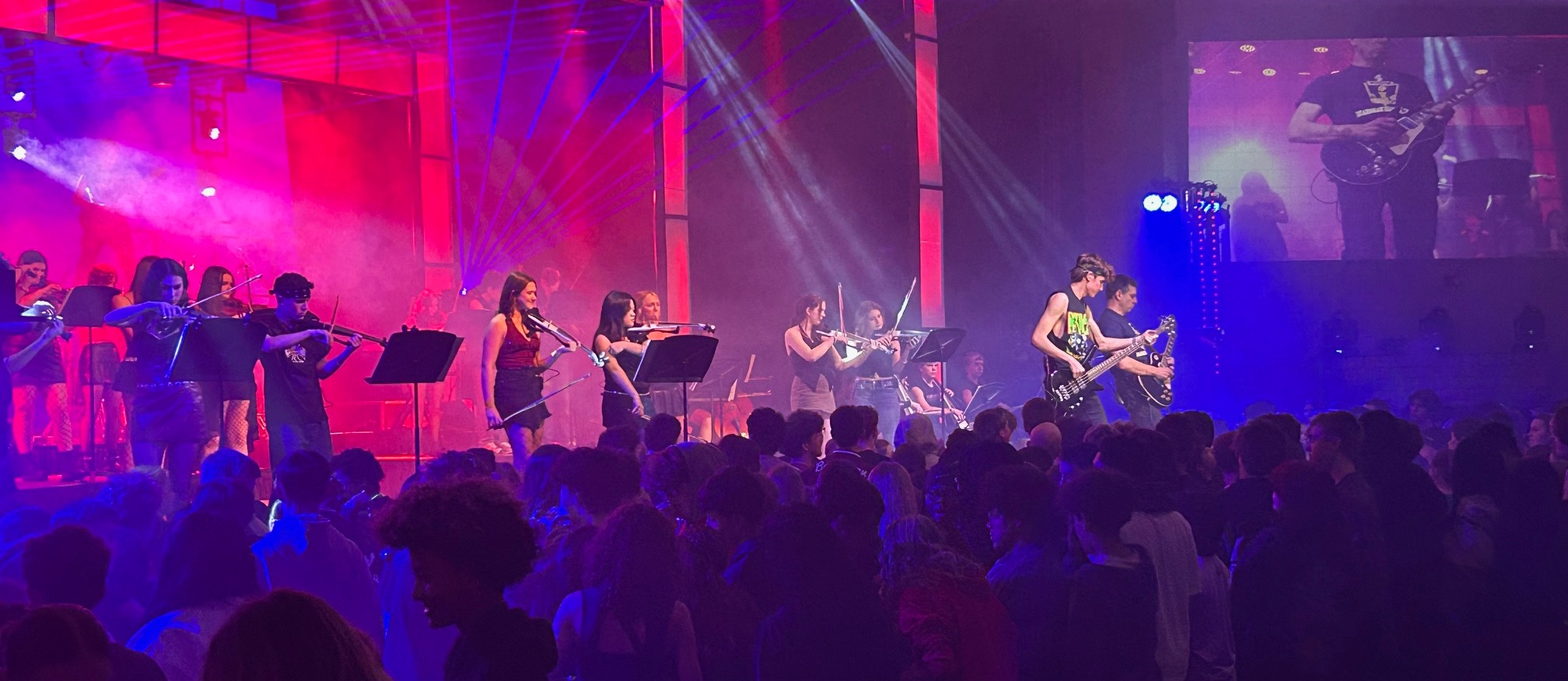 student musicians and singer on performing arts stage 