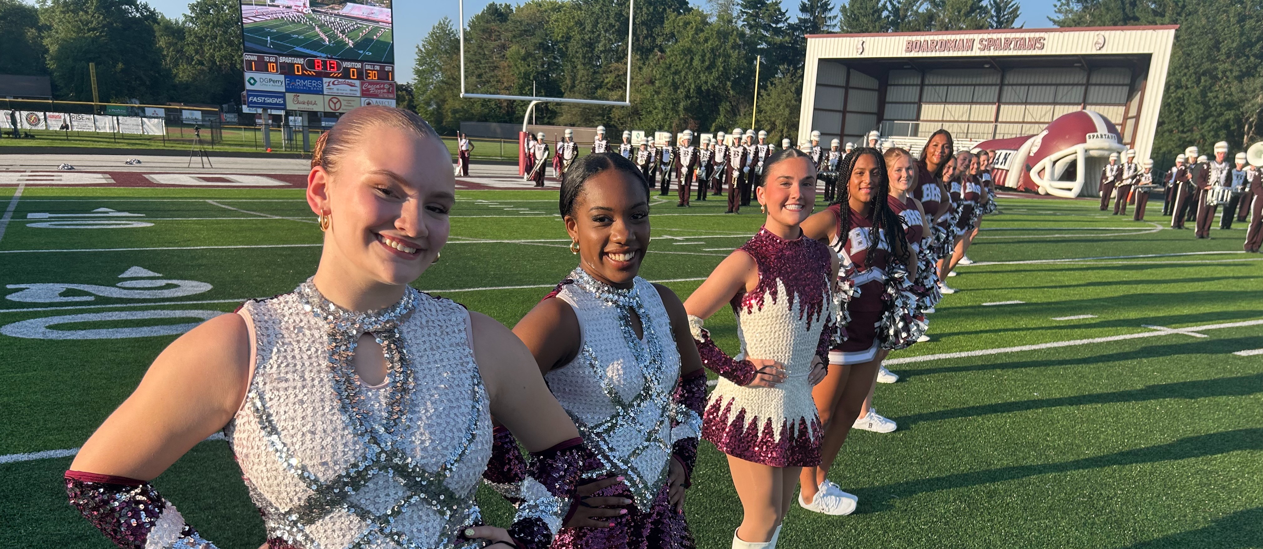 Band majorettes lining up for football team to come through on the field