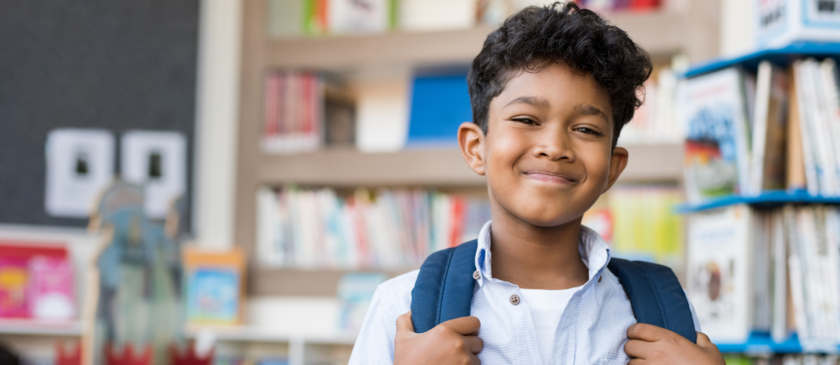 Student smiles in hallway