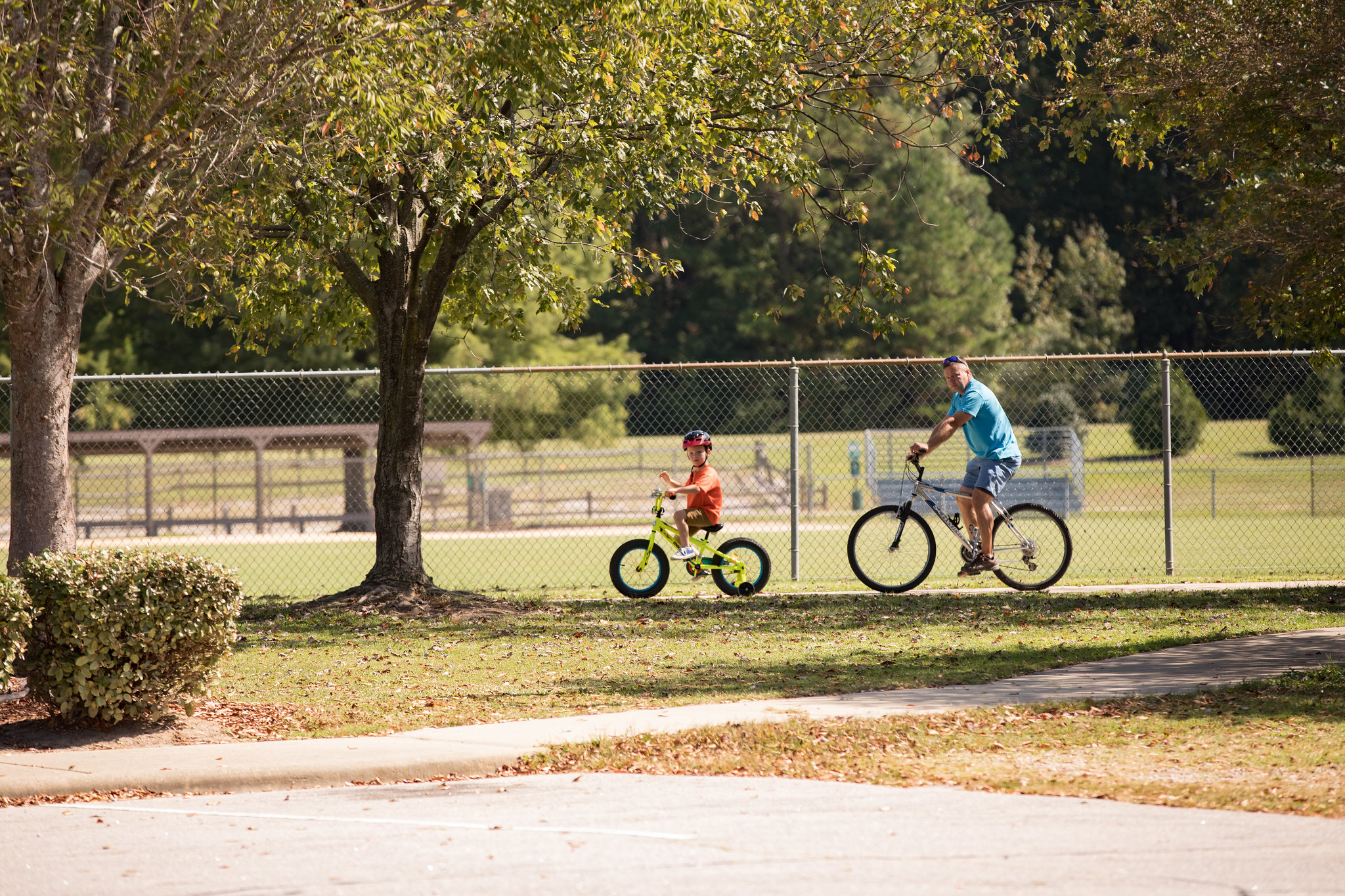 A father and a son riding bicycles