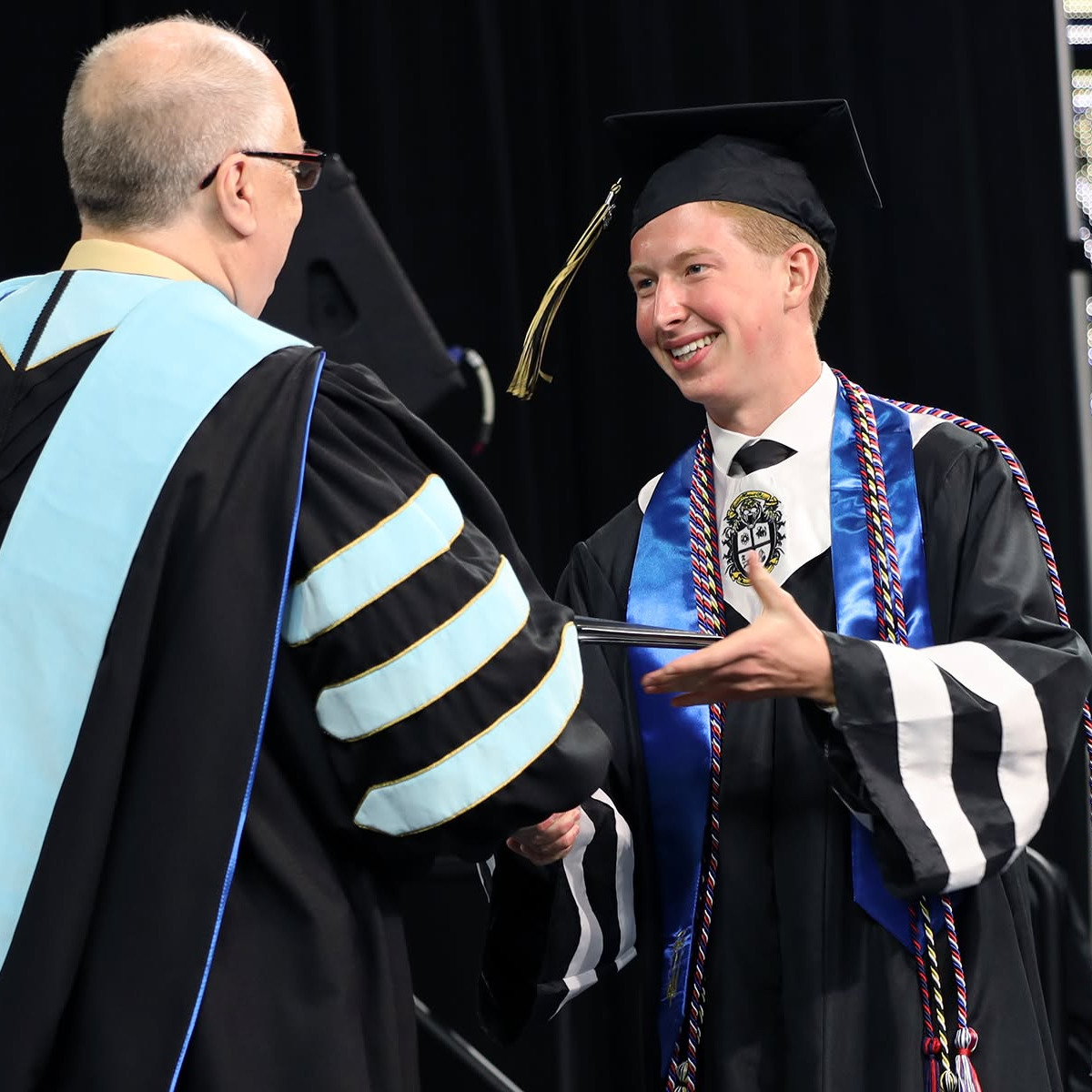 student accepts diploma from principal