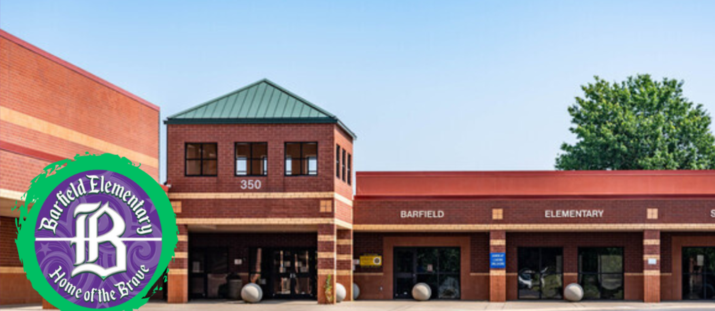 Exterior of a red building with arched windows and a green roof. Purple banner on the left.