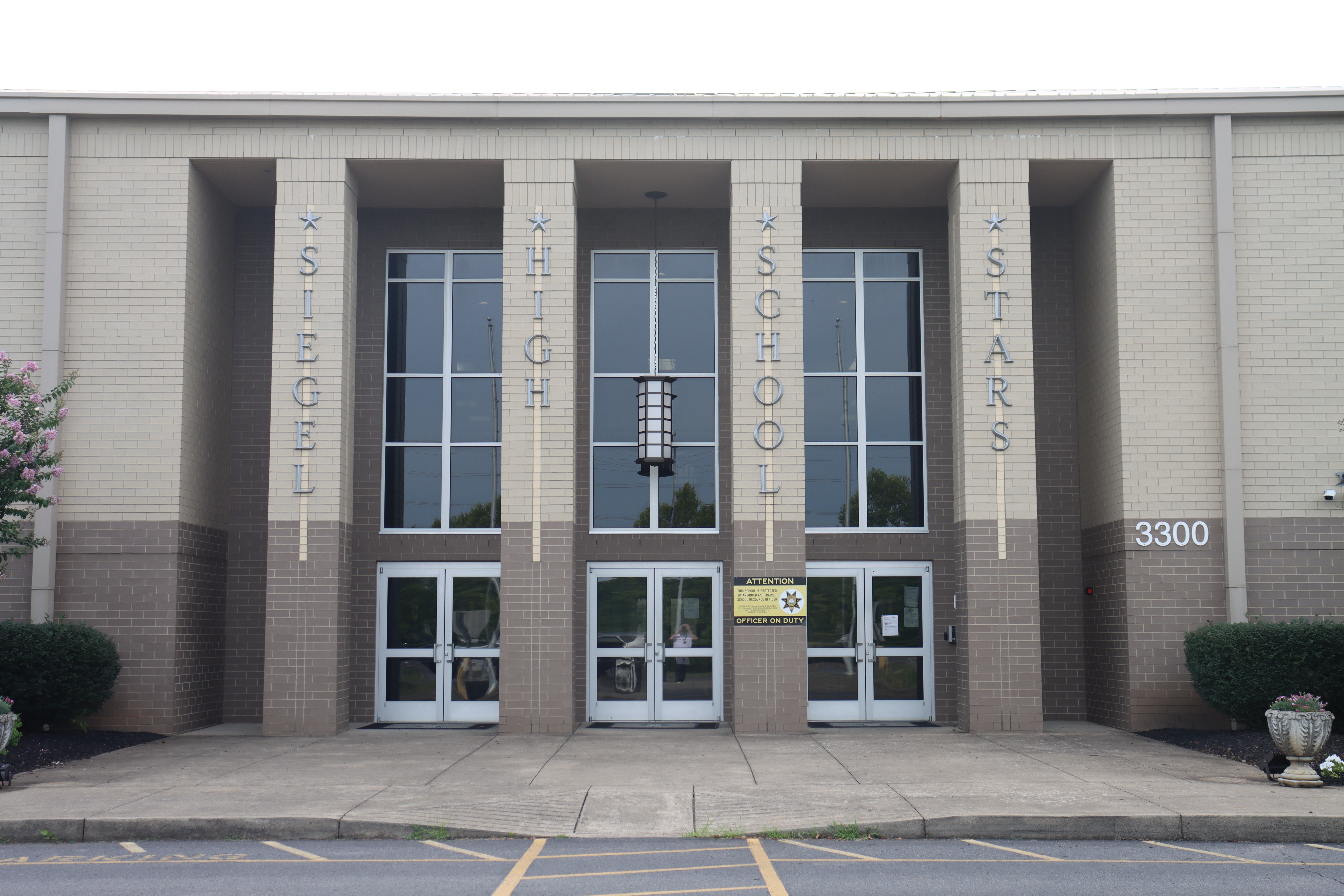 Beige Brick building with Siegel High School on the pillars