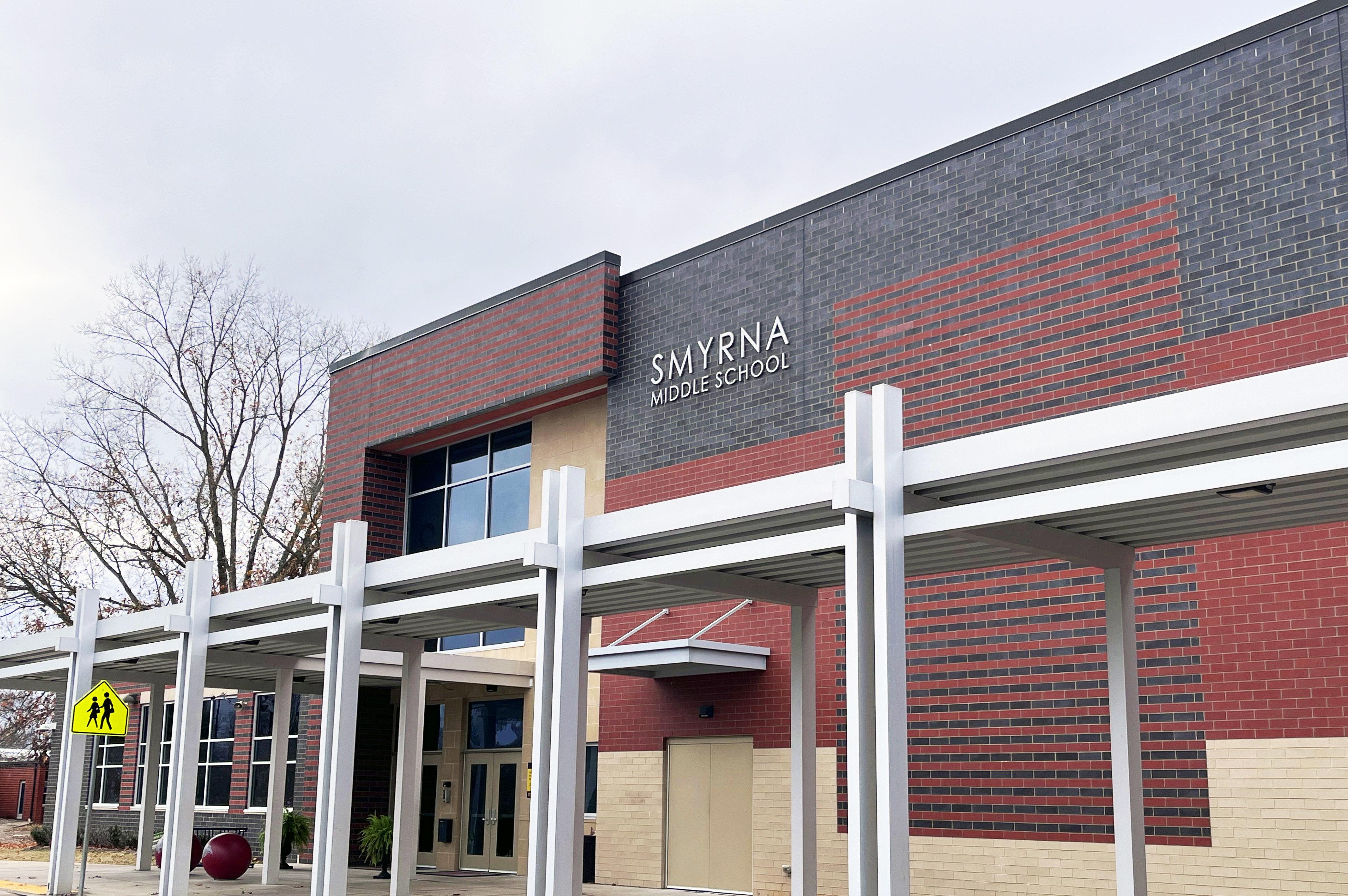 Maroon and black brick building with Smyrna Middle School on exterior
