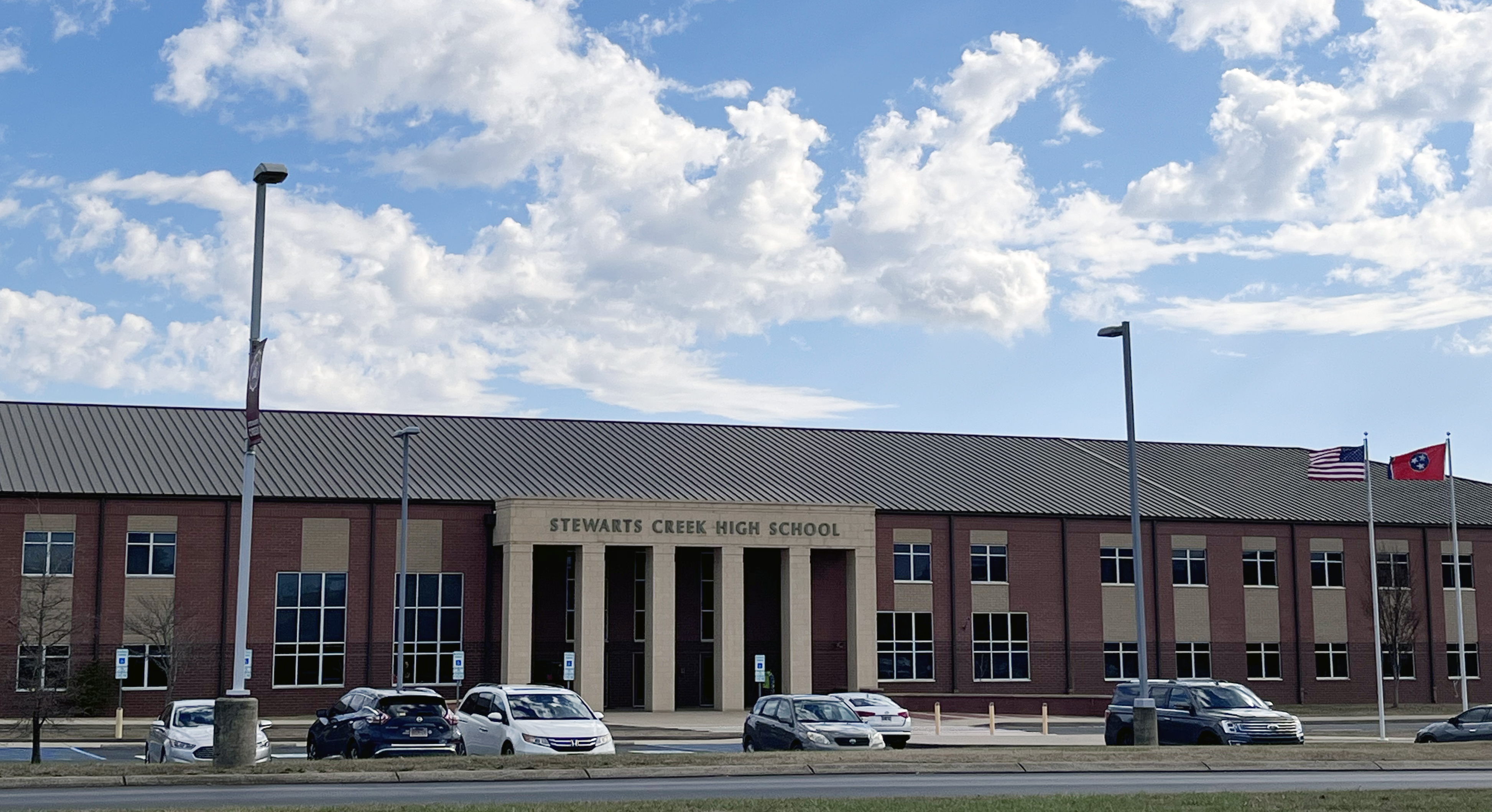 Beige Brick building with Stewarts Creek High School in black letters