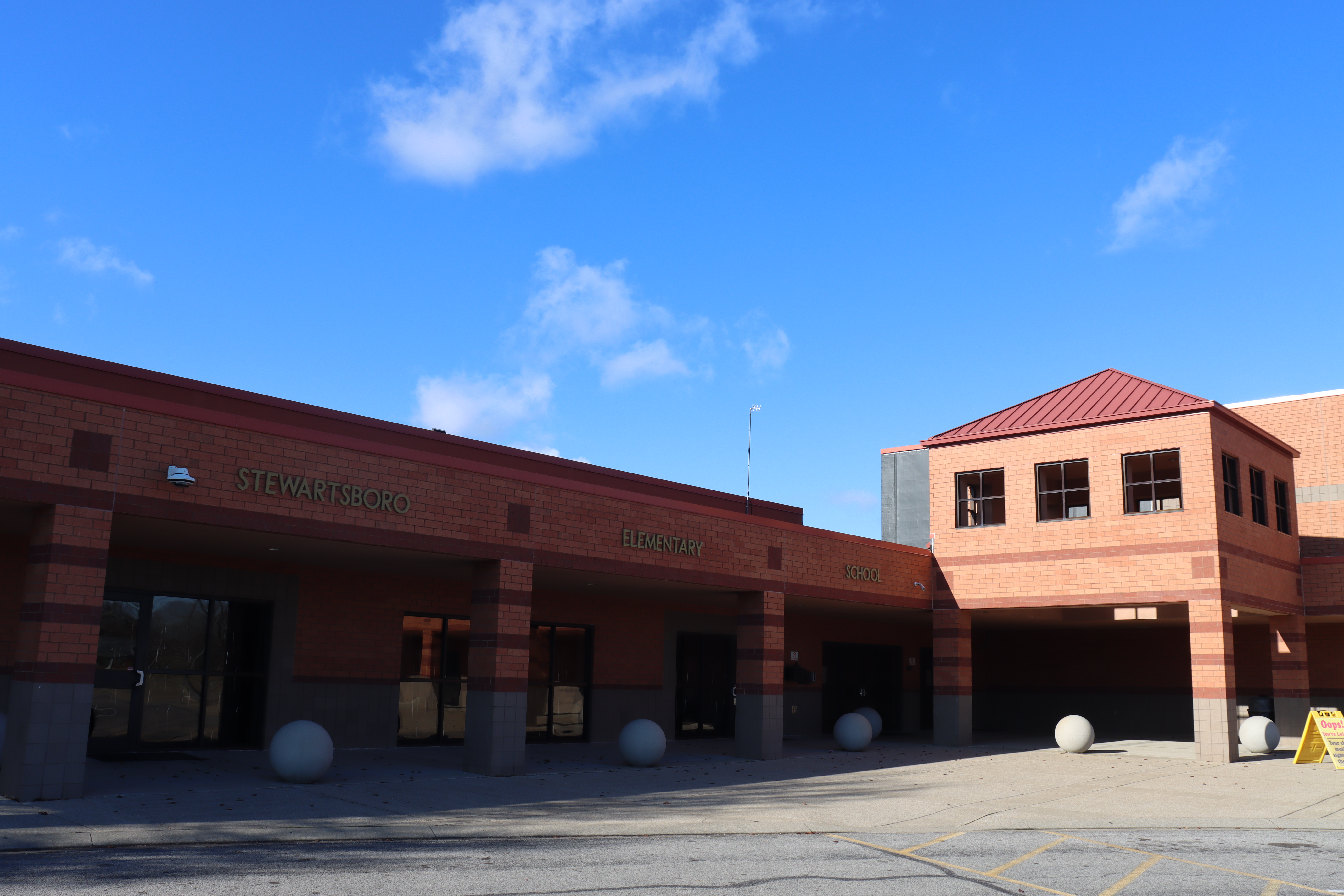Beige brick building with Stewartsboro Elementary School in blue letters