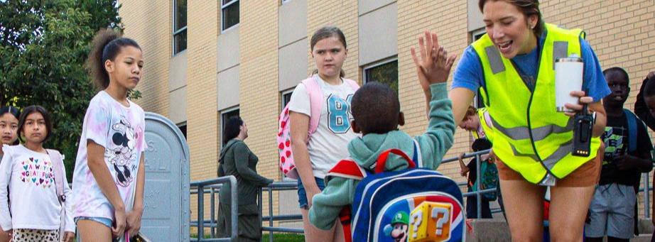 McPhee student high-fiving a traffic guard