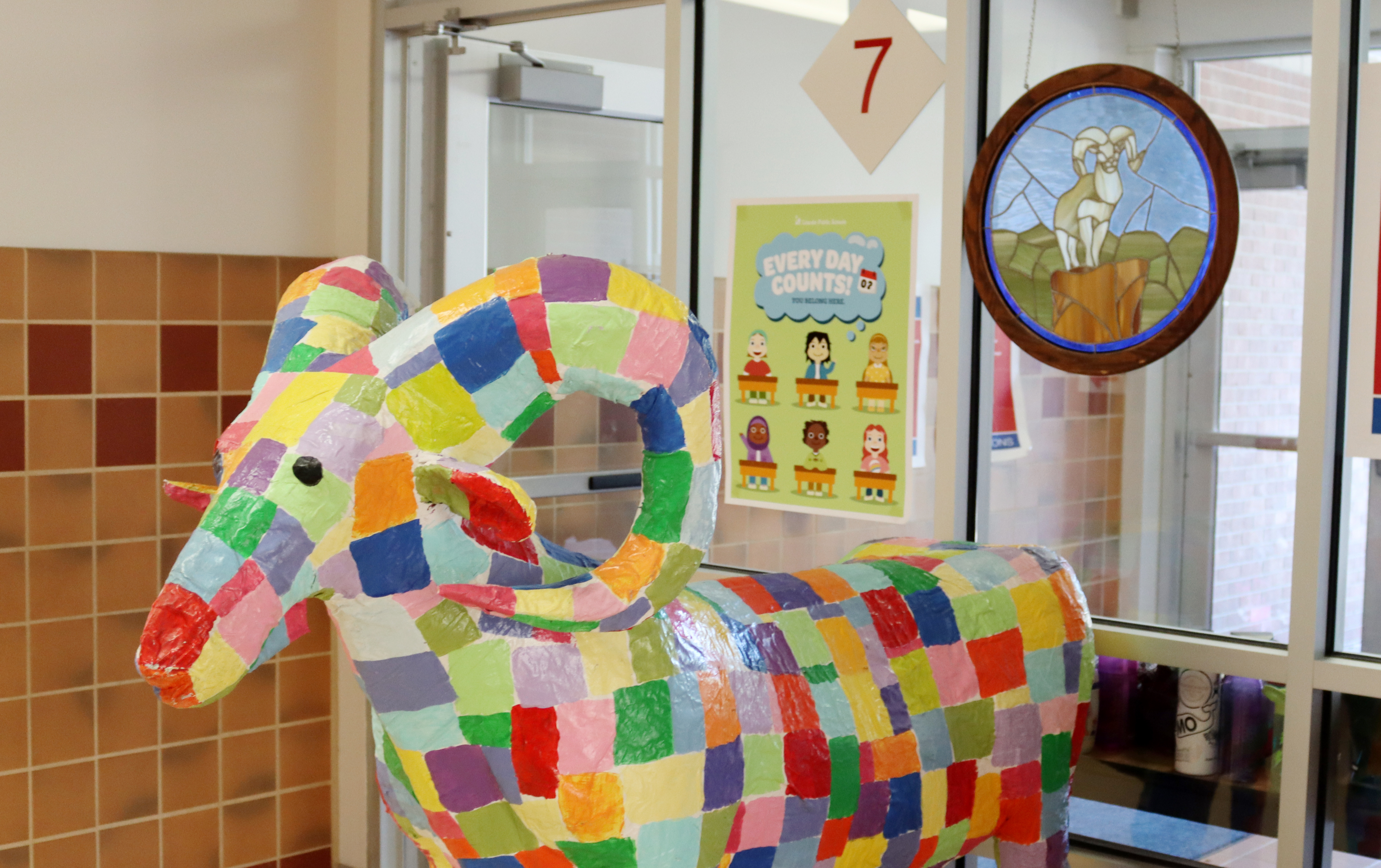 A colorful ram sculpture displayed at Rousseau Elementary