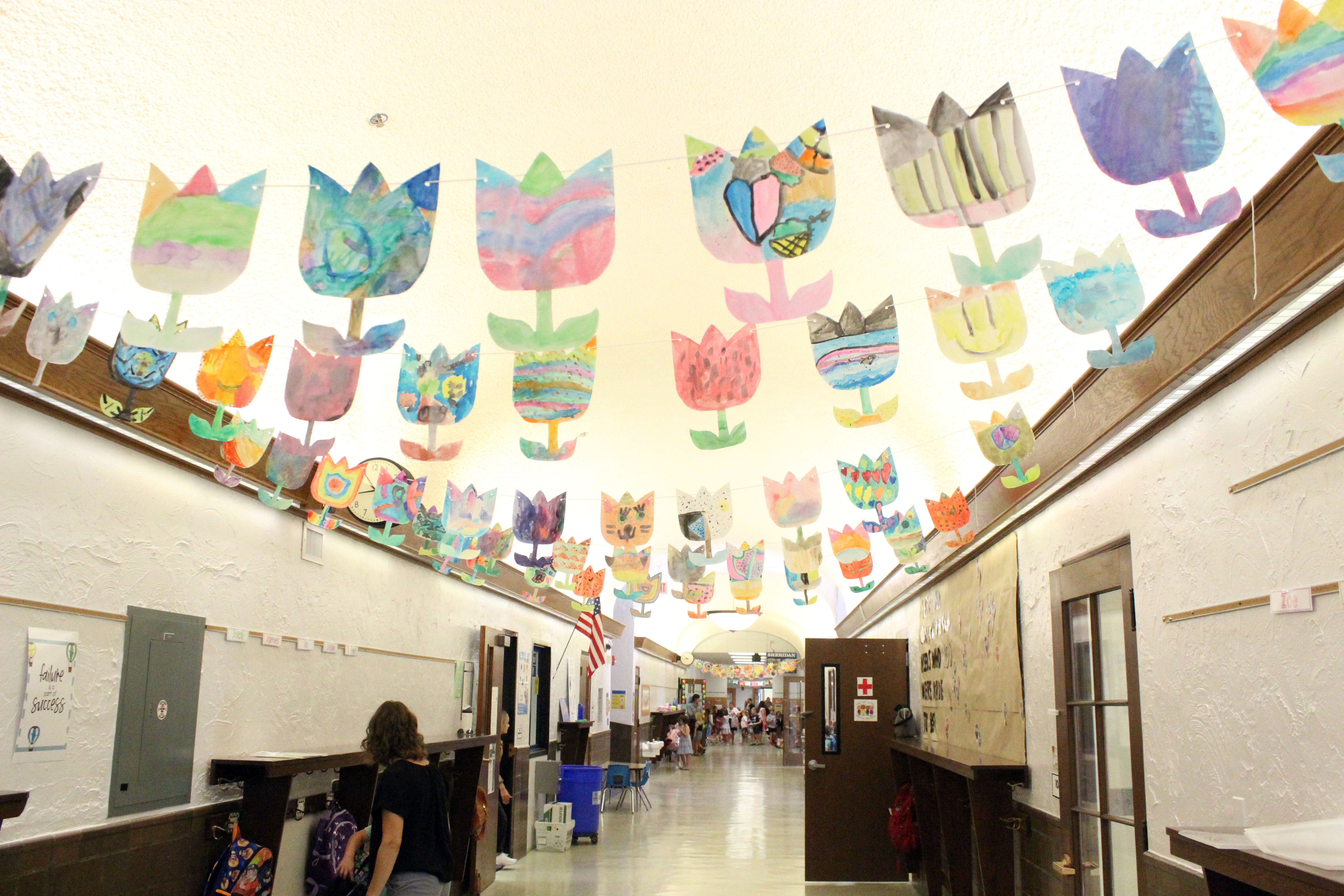Sheridan school hallway with many colorful banners hanging from the ceiling