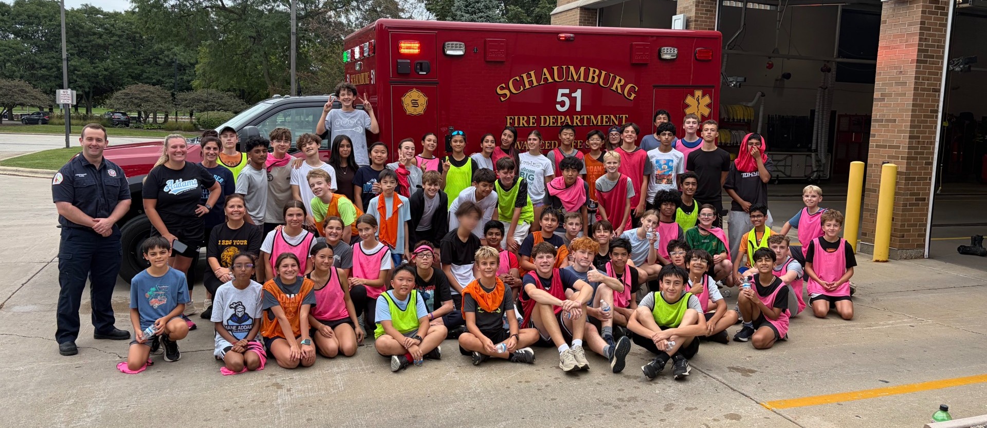 Students posing outside a fire station