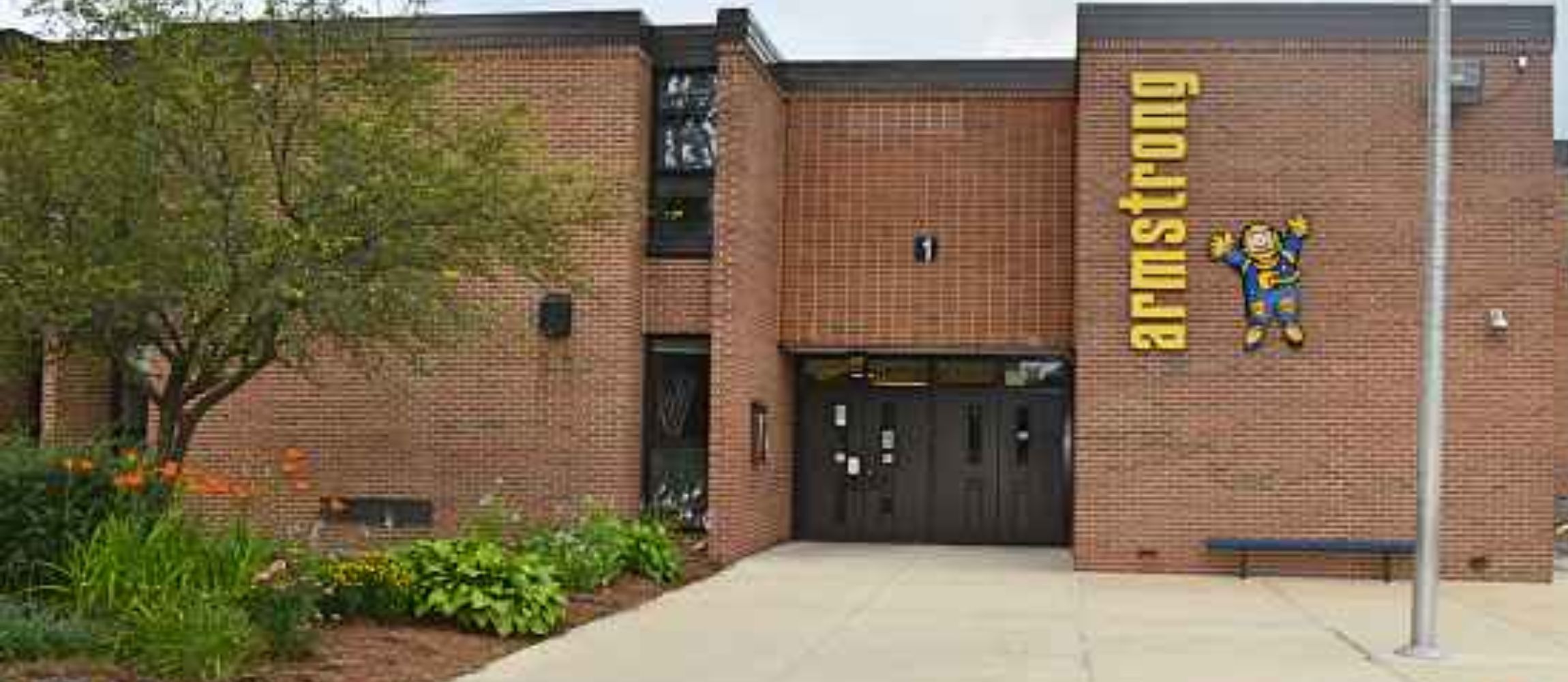 Armstrong School brick building with Astronaut and Armstrong on the building