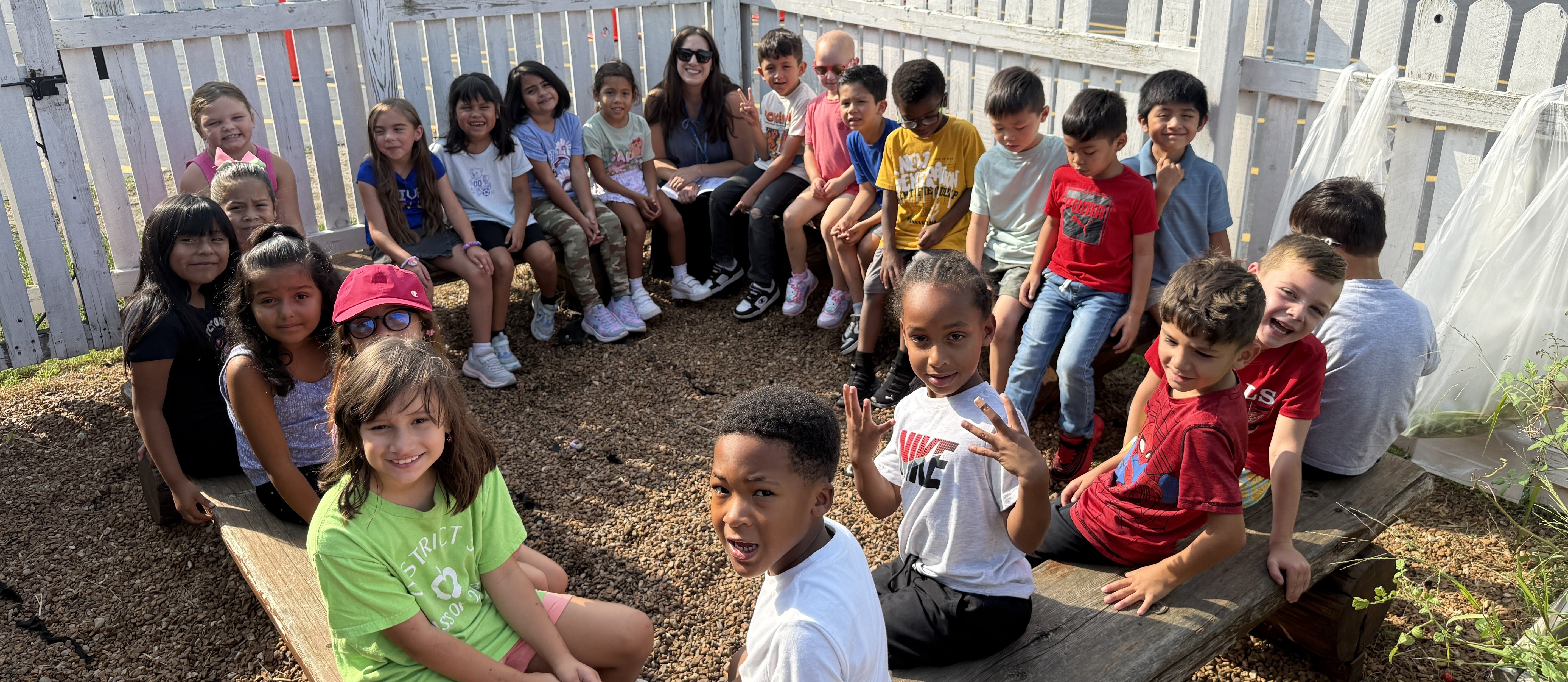 kids in garden area sitting on benches
