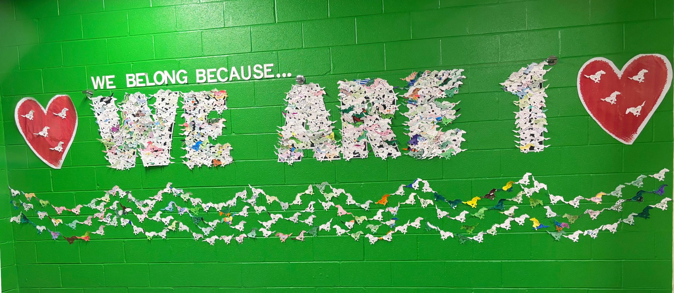 We Are 1 on wall decorated by students