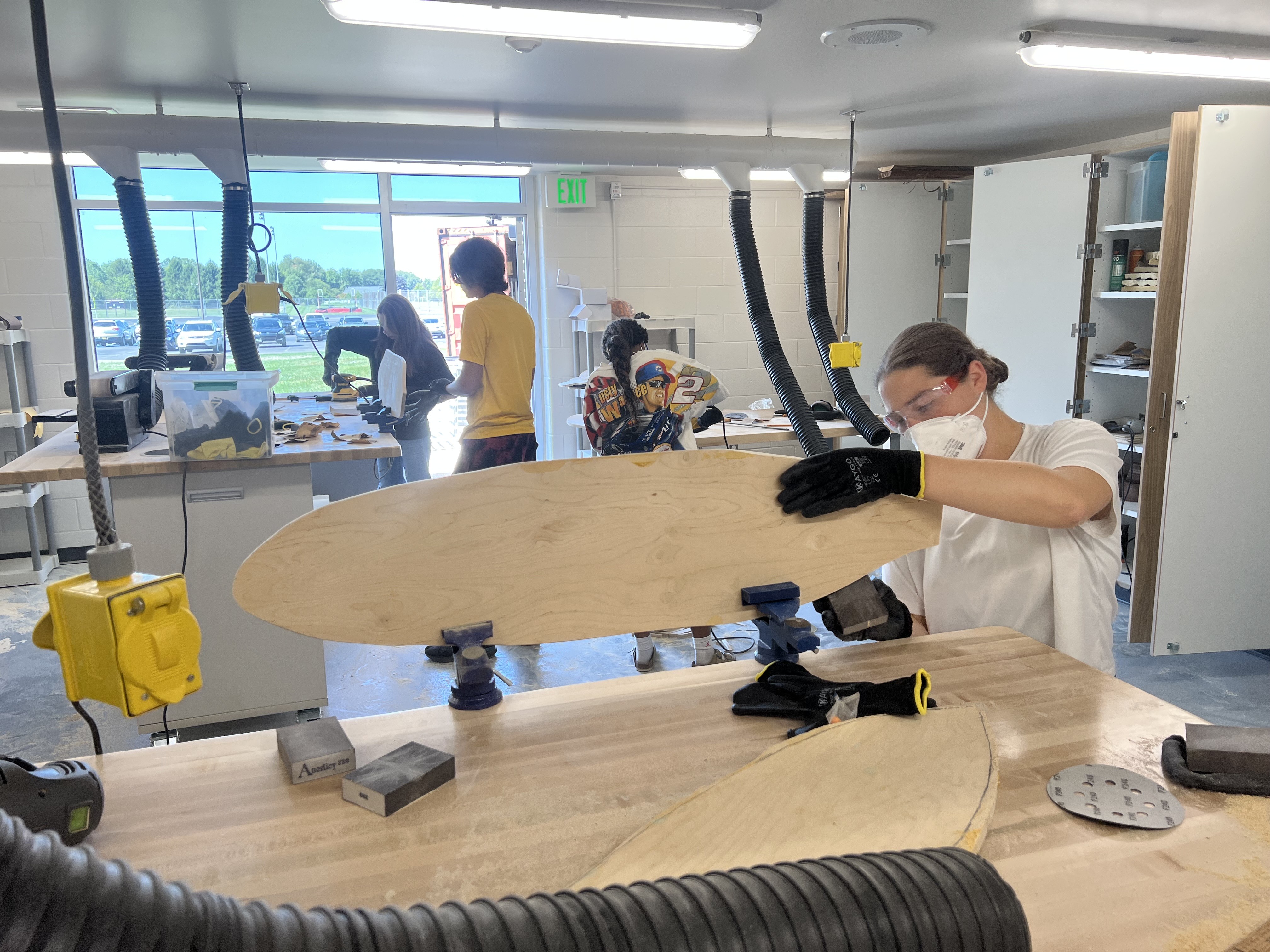 Gone boarding student works on her board.