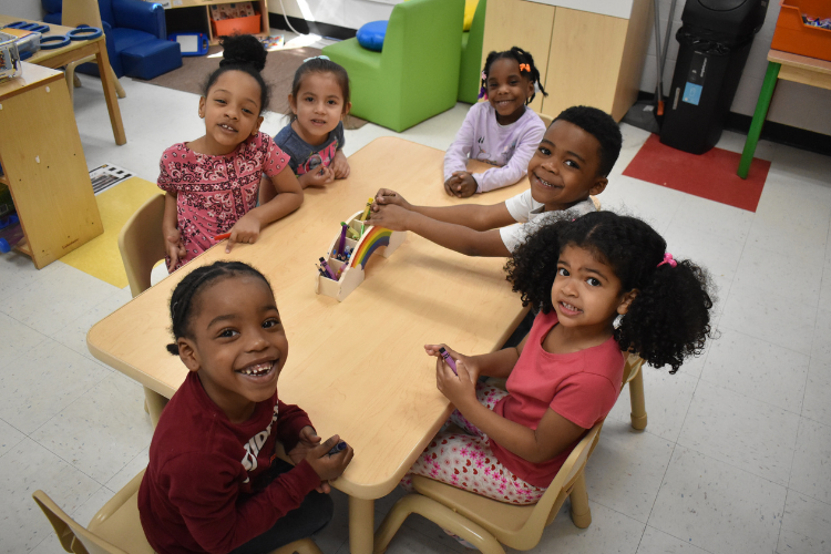 a group of six Pre-K students smiling