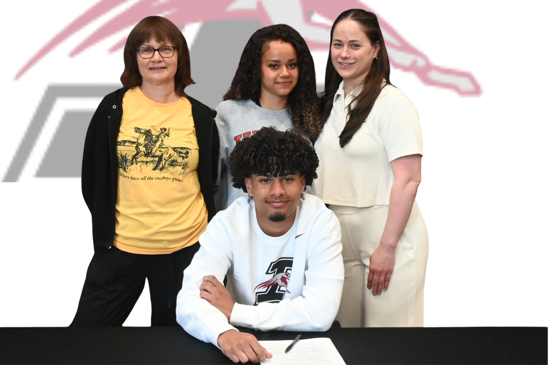 Five people stand behind a table. One is signing a document. They wear casual clothes. The text reads "JAYLEN SPRINGER SIGNED BOYS SOCCER".