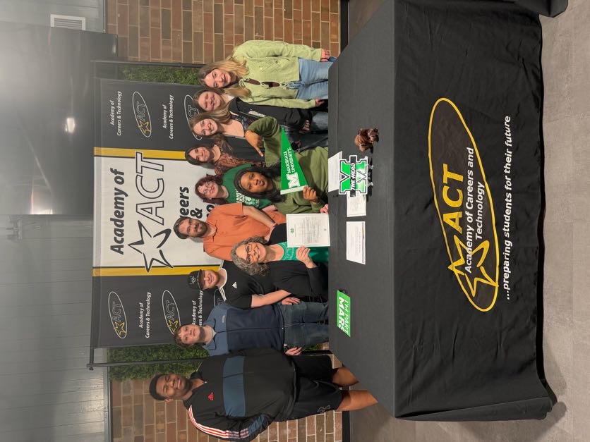 Academy of Careers and Technology student R'rhianna Holland celebrates signing her letter of intent to attend Marshall University with her ProStart Restaurant Management class and a college representative.