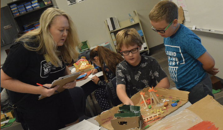 Students and teacher using supplies from grant money