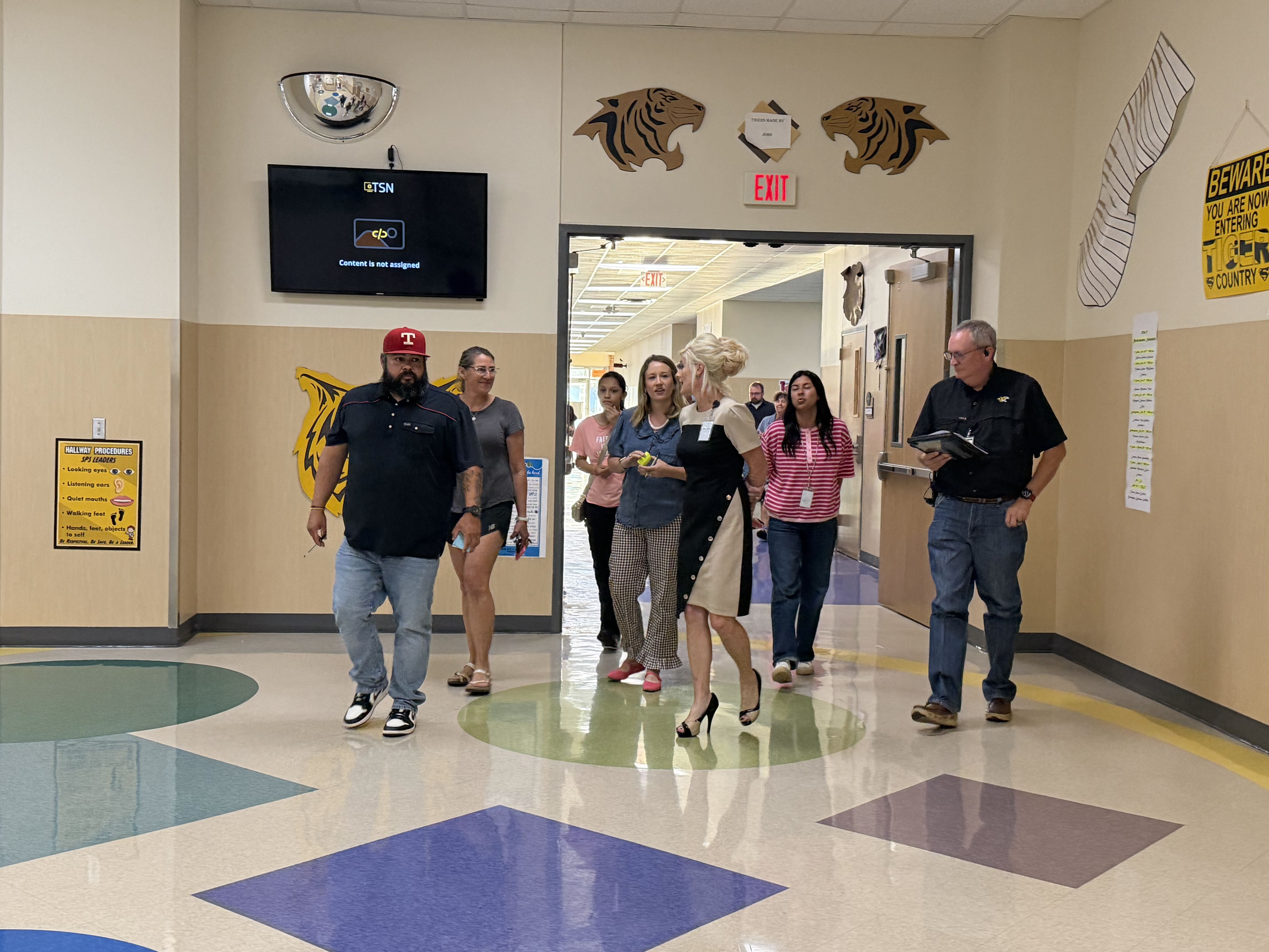 Committee members tour an SISD school