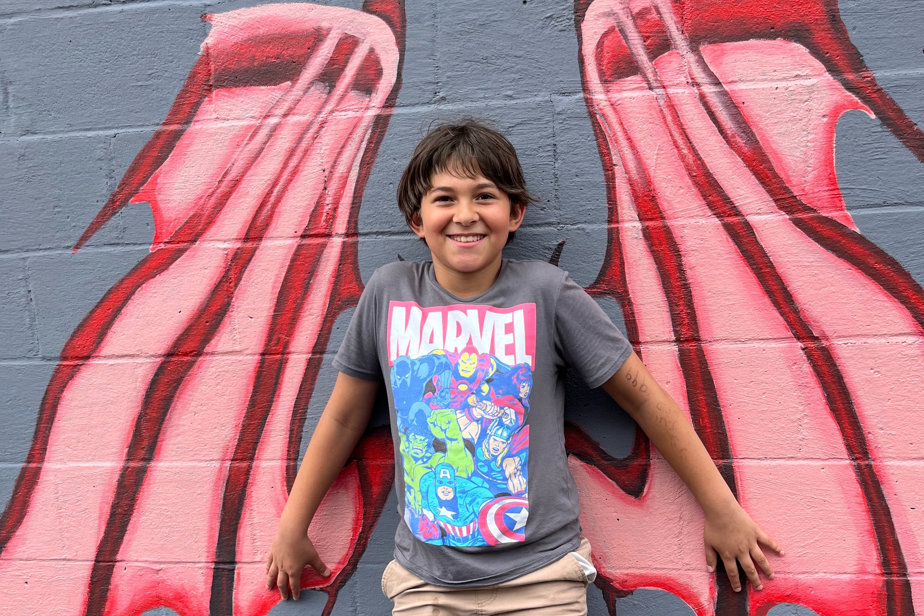 student on a mural with wings
