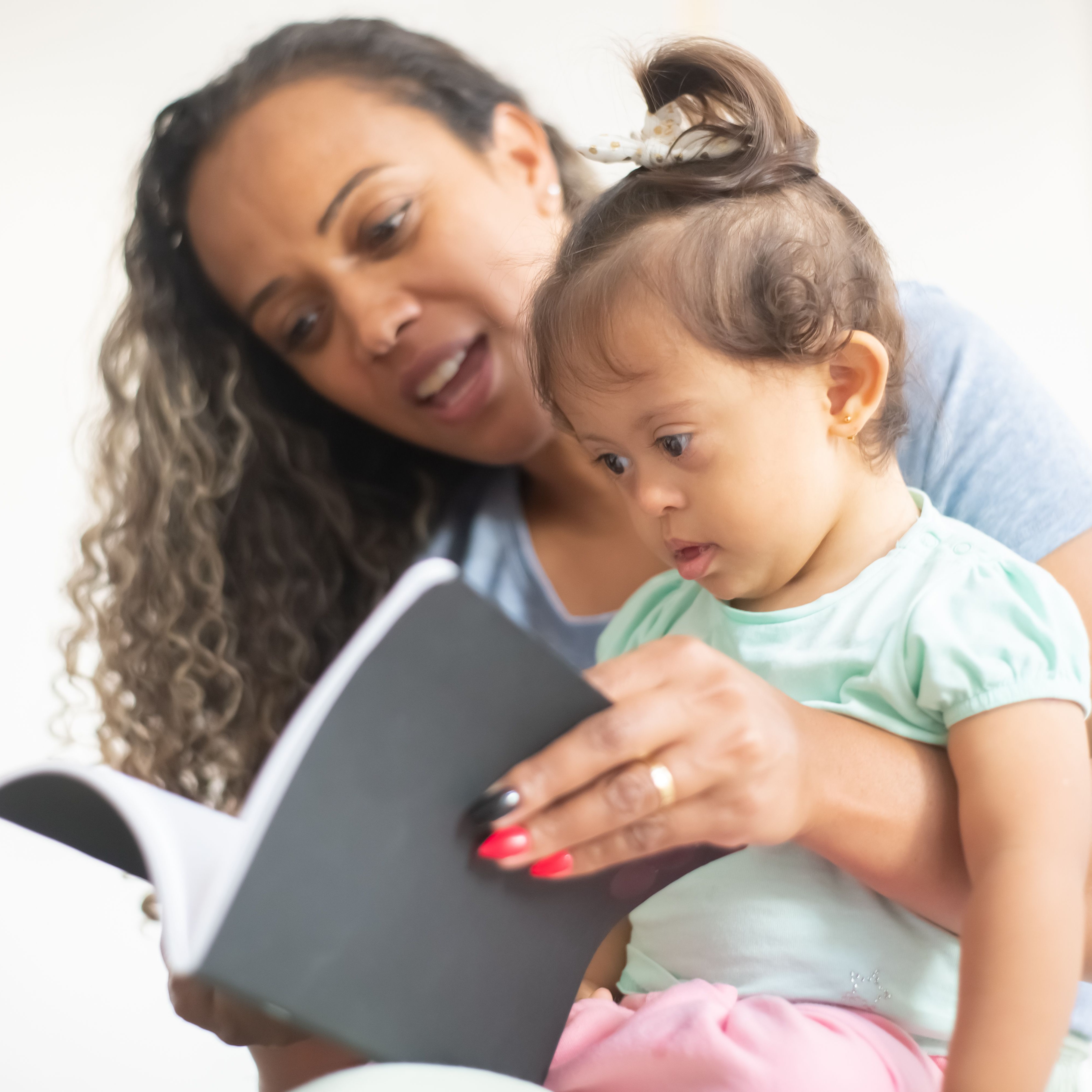 Adult reading to baby
