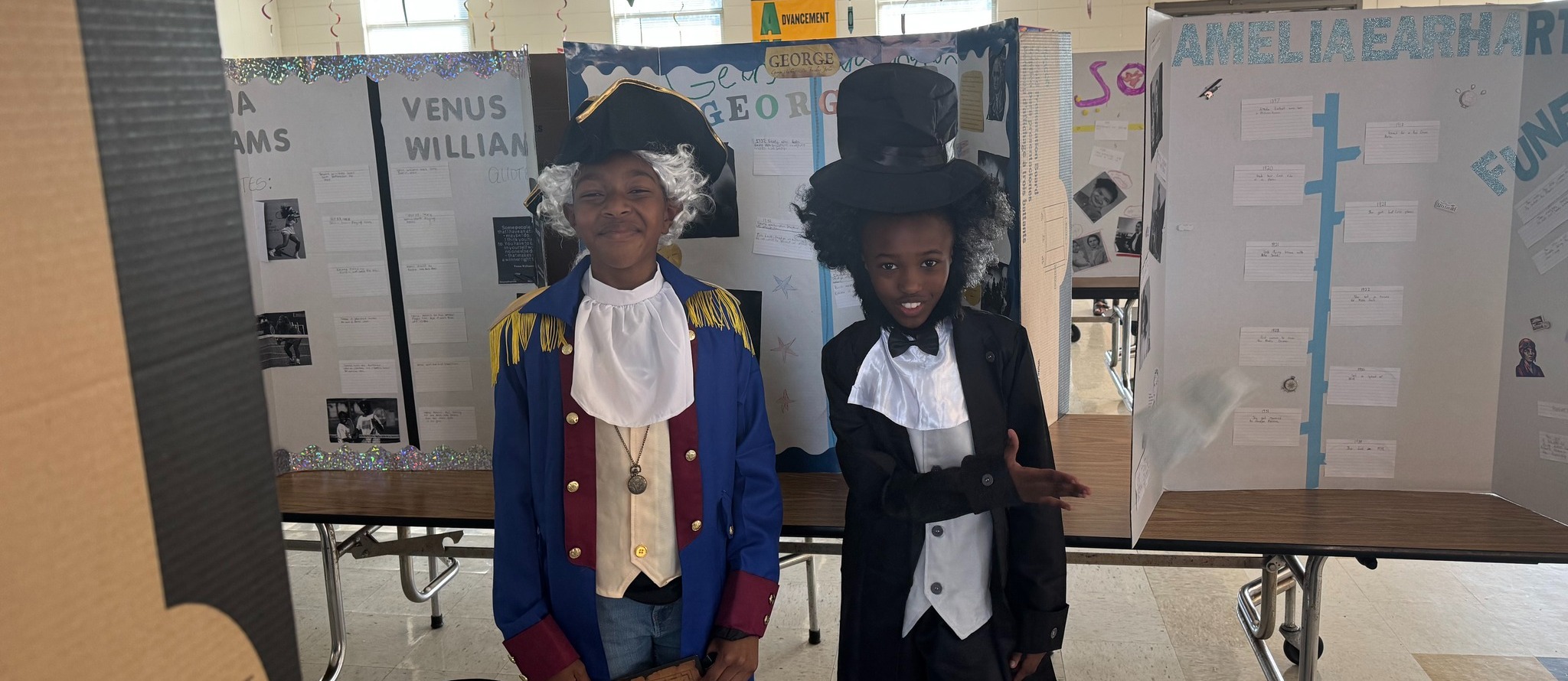 College Station MAR  Slider of two students dressed as historical figures George Washington and George Washington Carver