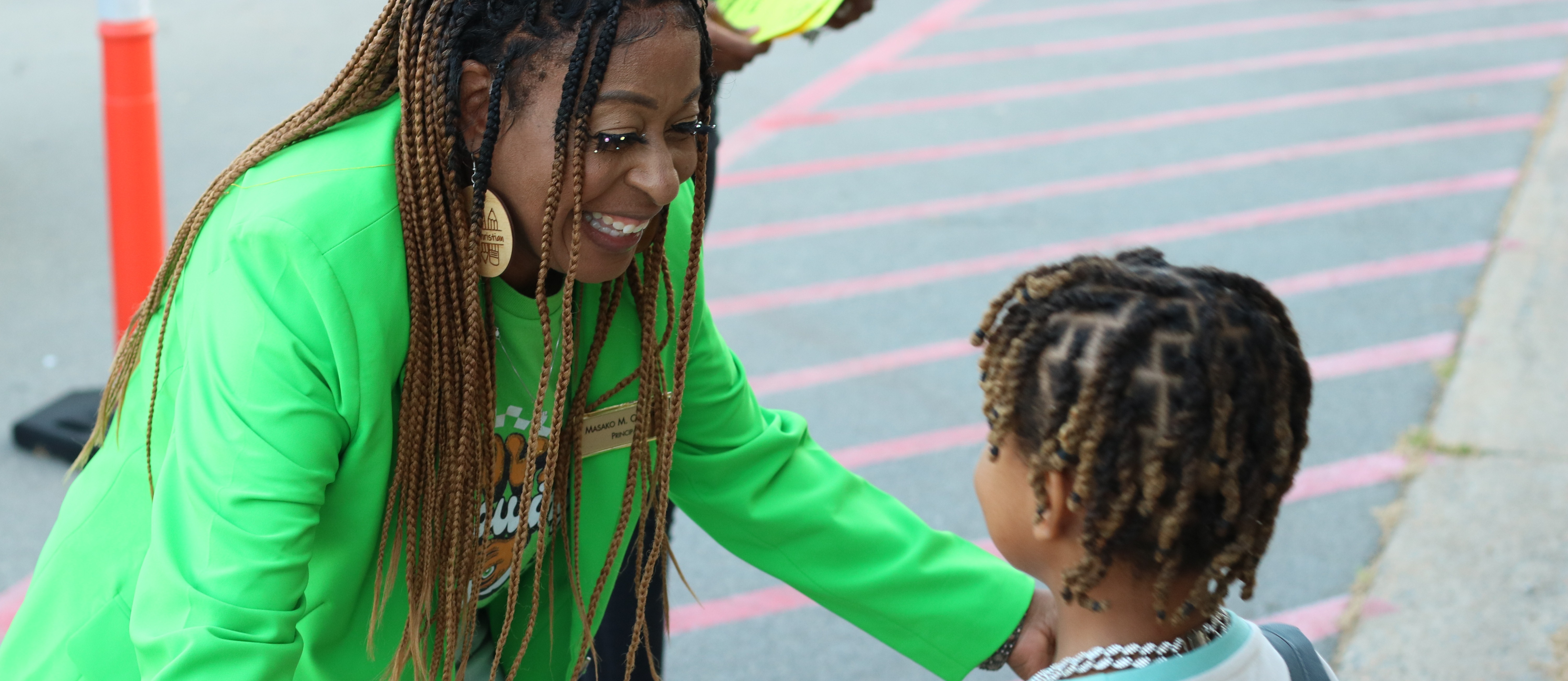 Principal Masako Christian preparing to hug a student