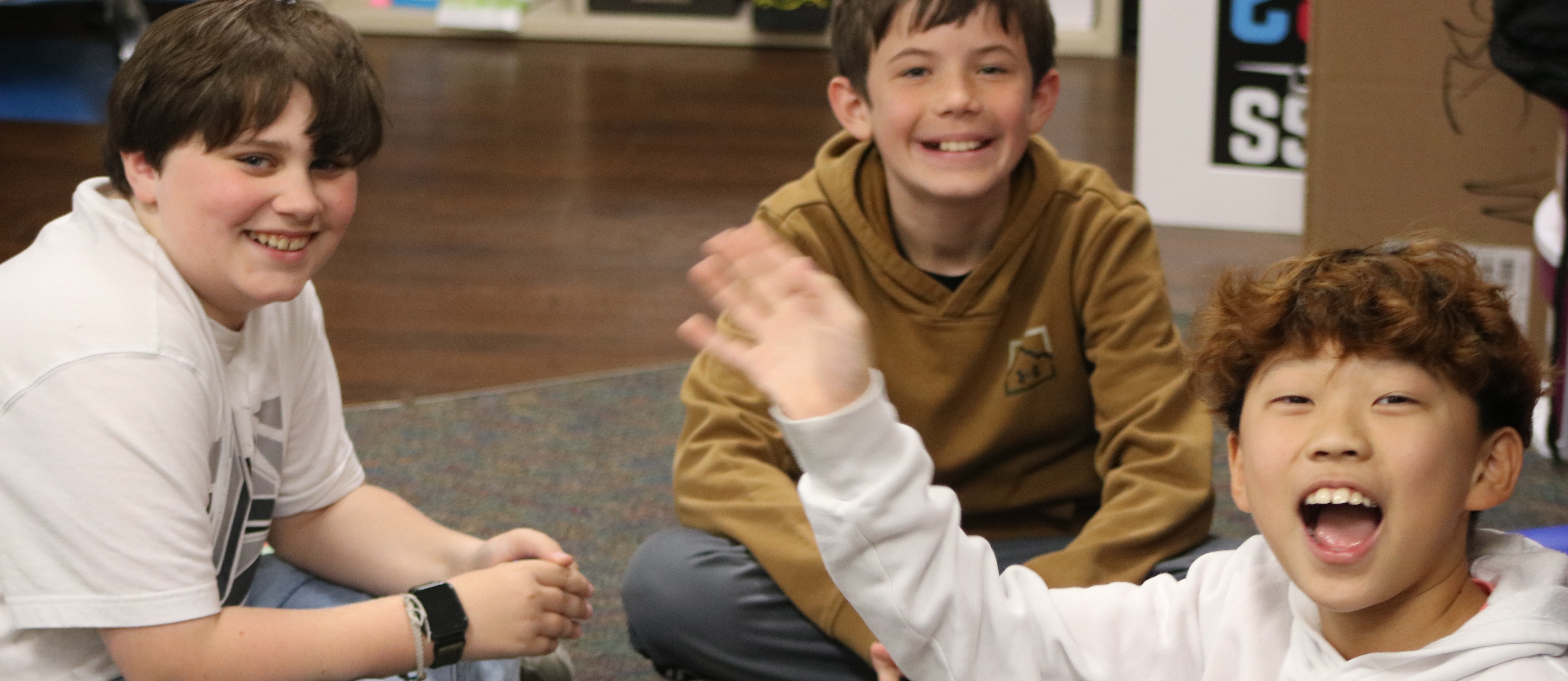 RES MAR slider with students sitting and smiling at the camera