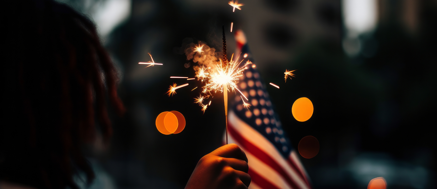 child holding sparkler and american flag
