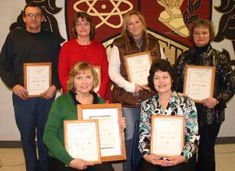 teachers holding awards fro group picture