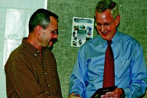 Rick McCully is presented the 2010 Beacon Award by Ed Douglas.	