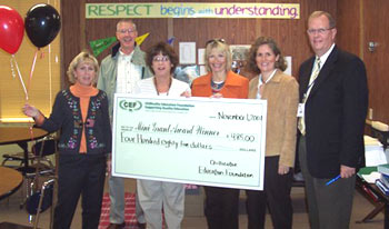 teachers holding big check