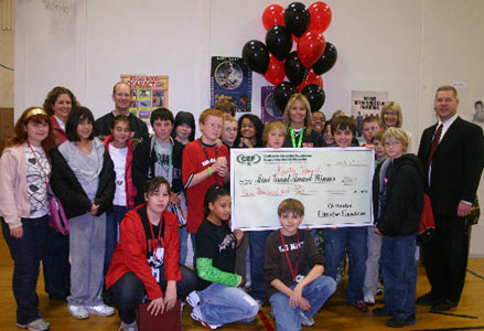 teachers and students holding big check