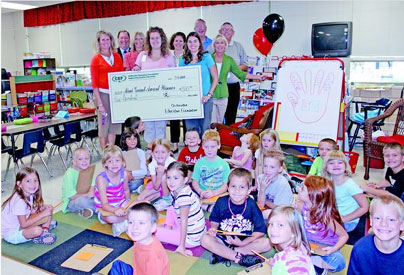 staff taking picture with big check