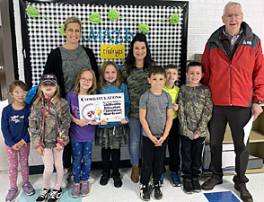 staff and students taking picture with award