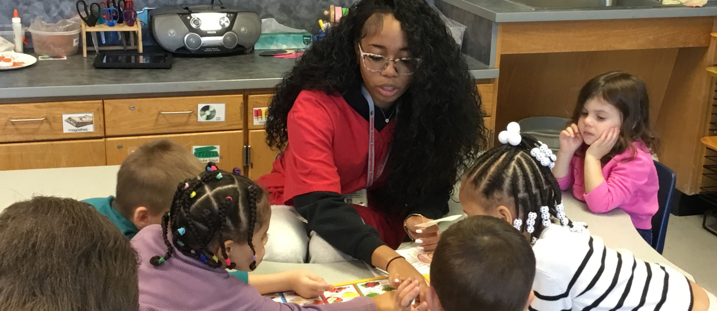 CTE student working with children at a table