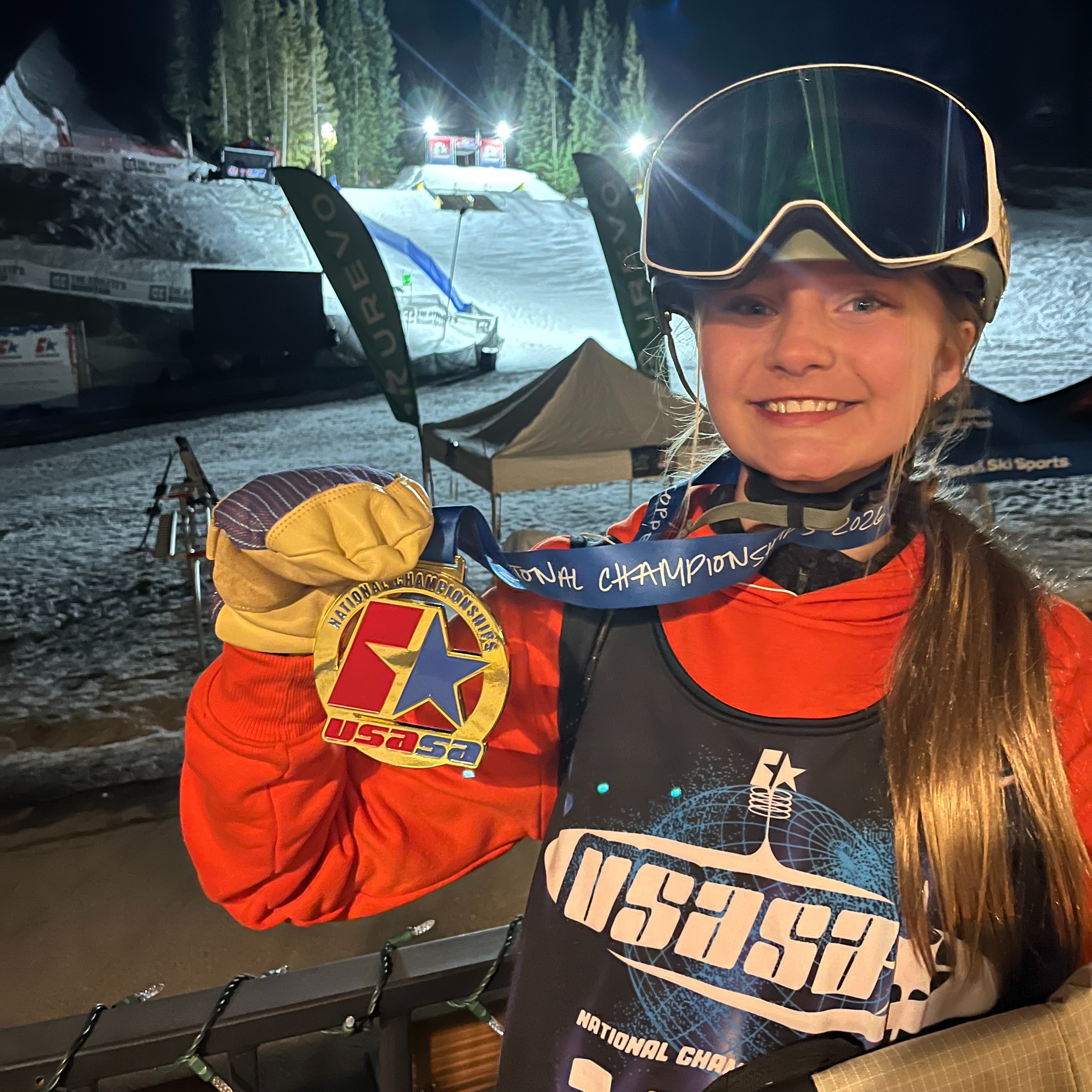 Lillian Larsen from Proctor Middle School poses with her gold medal from crowned National Champion when she placed 1st in the girls' 13-14-year-old rail jam competition!