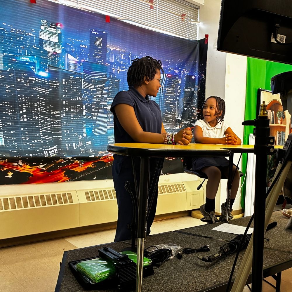 Students doing morning news program at elementary school
