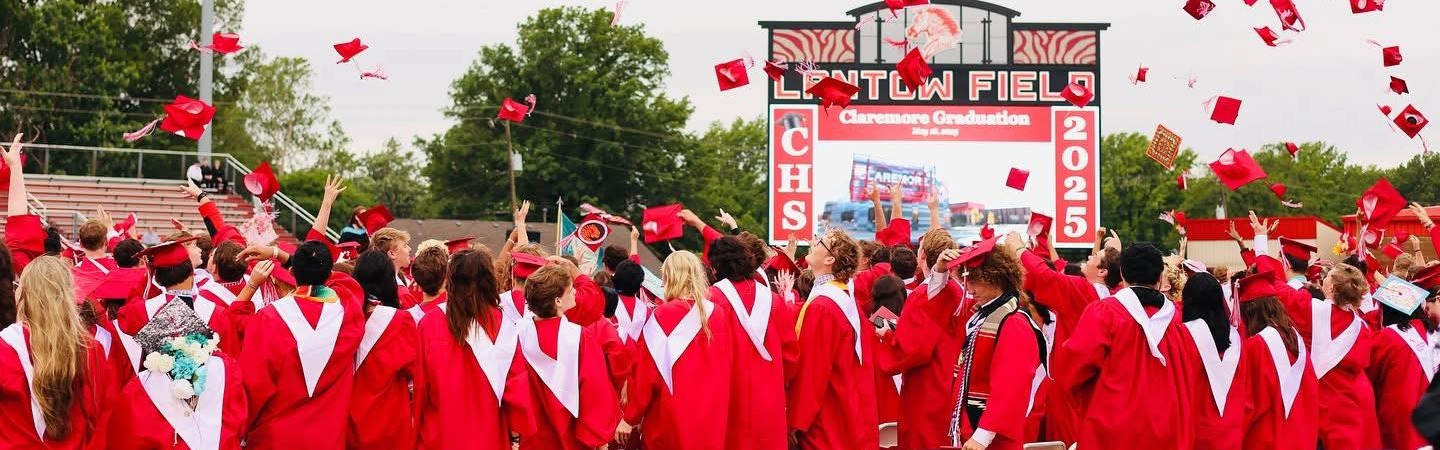 students throwing grad caps  up