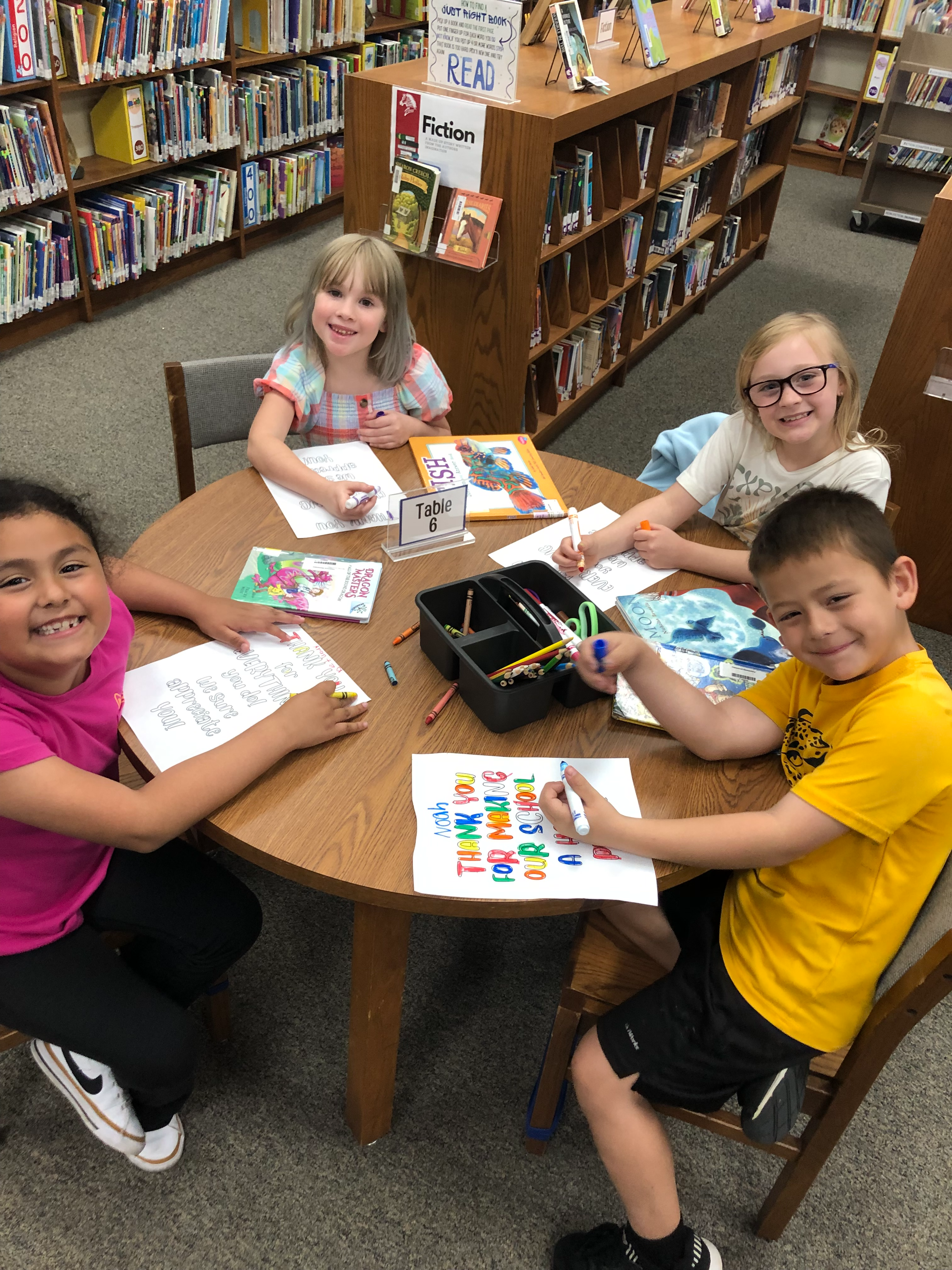 Children in the Claremont Library coloring and enjoying their time.