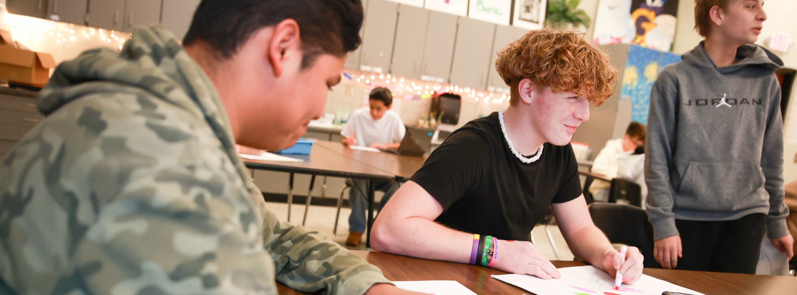 Rainbow Lake Middle School students are in class drawing.