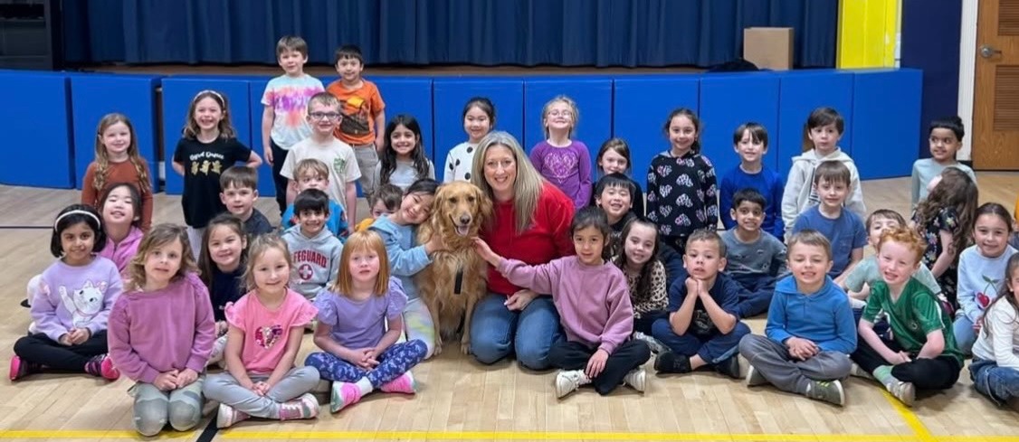 Stella therapy dog with group of byrd students