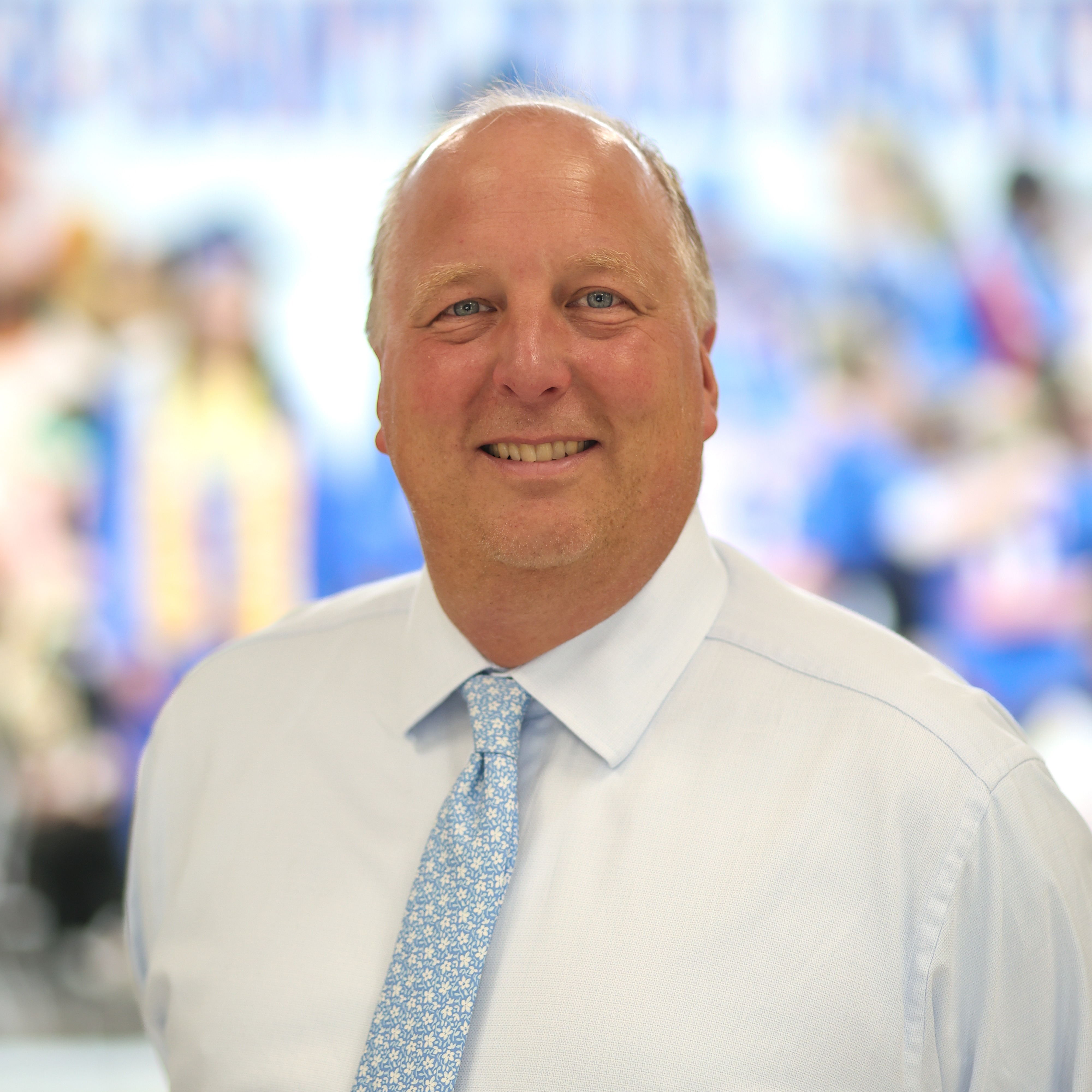 Smiling man with white shirt and blue tie