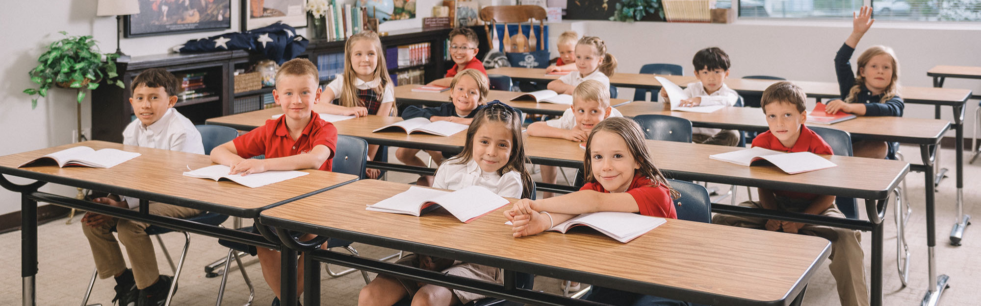 A class of students sit at their desks.