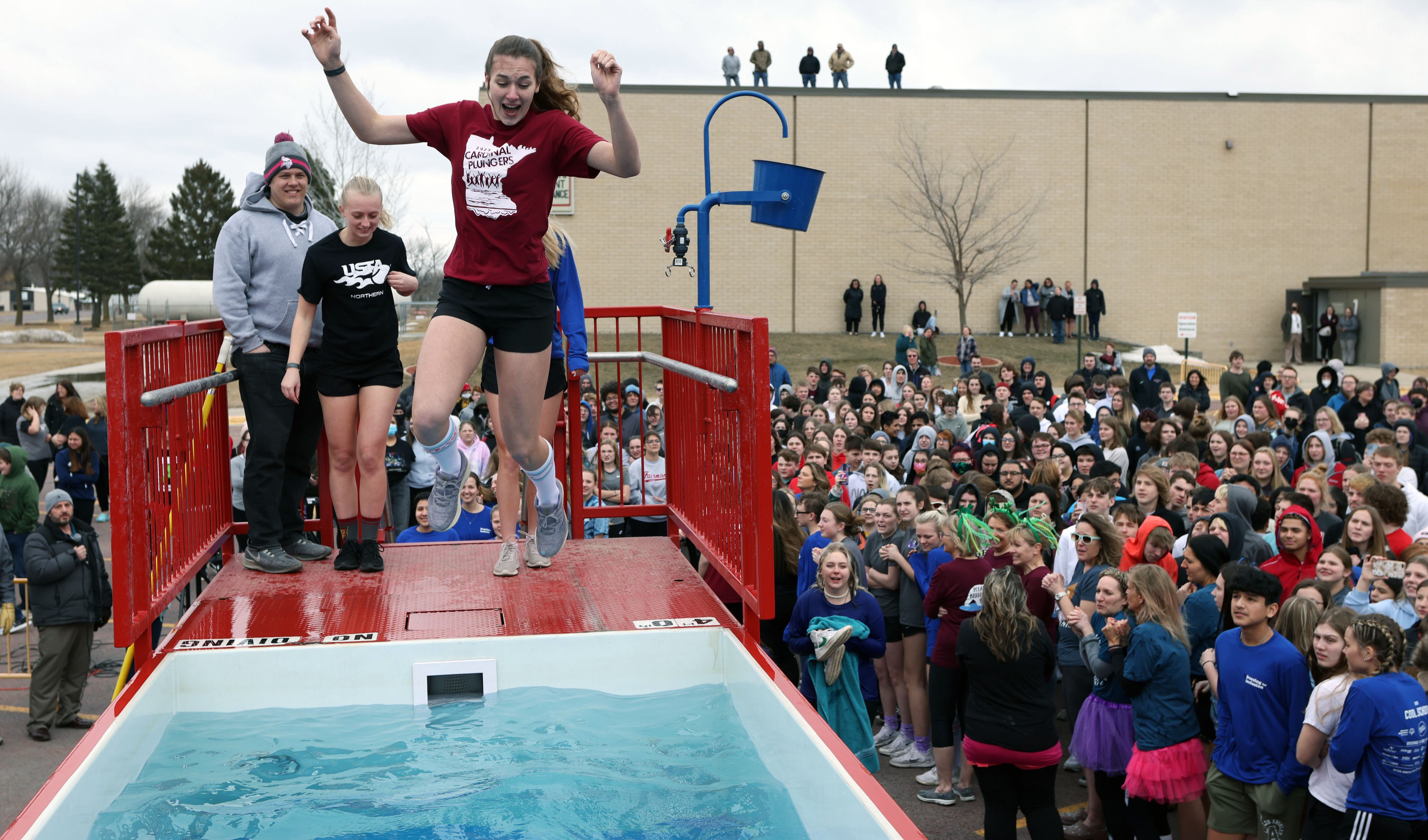 Students jump into polar plunge pool in school parking lot