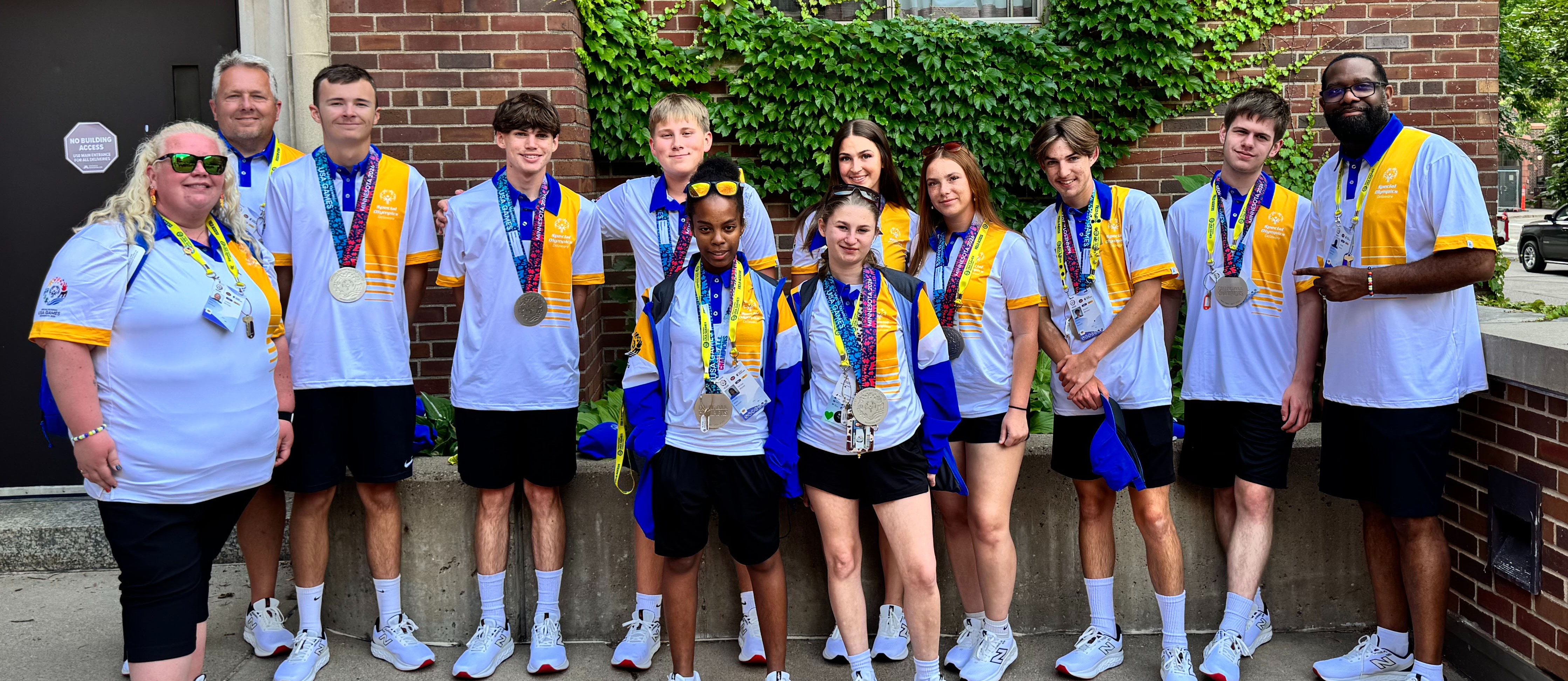 Unified sports team posing with silver medals